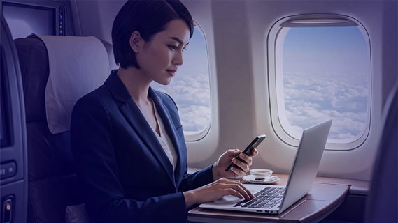 Woman on her Smartphone and Laptop Business Class